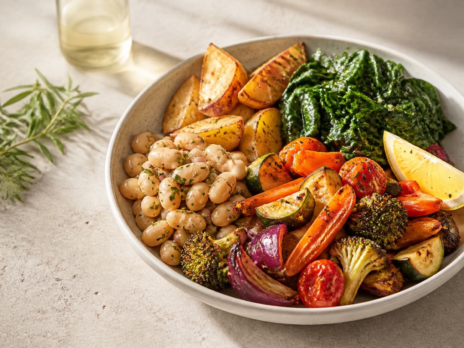 A satisfying bowl of roasted vegetables, white beans, potatoes, and greens